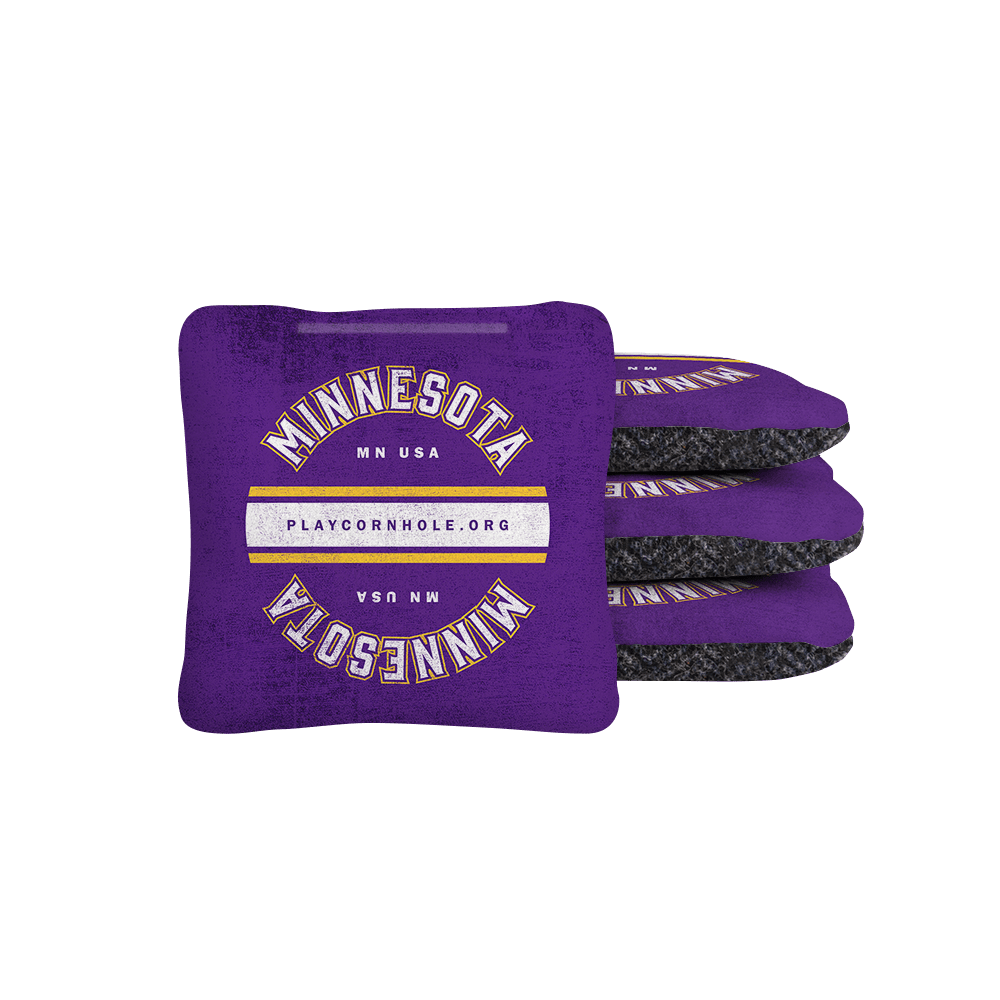 Purple and black cornhole bags with 'Minnesota' text on a white background